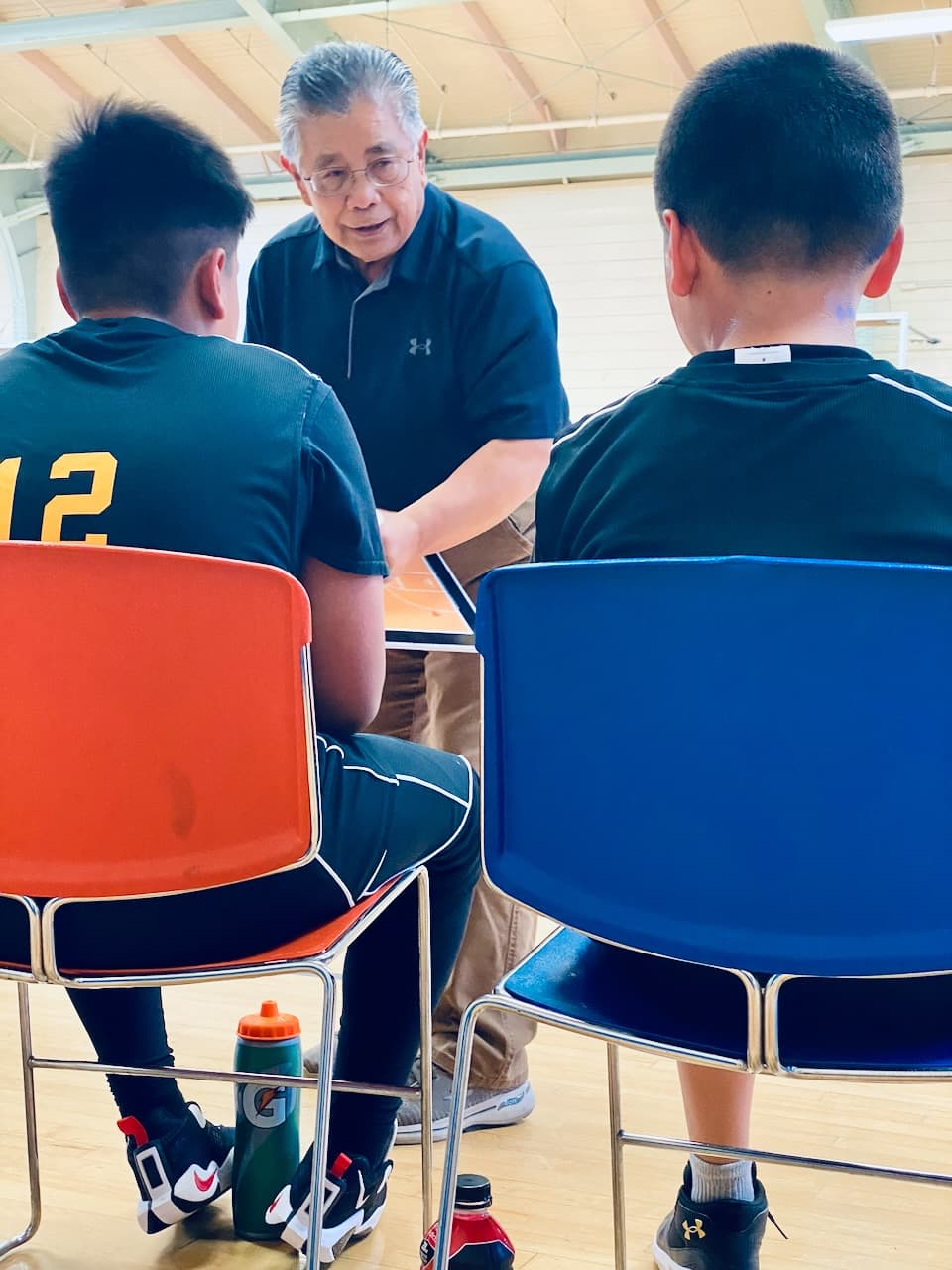 Coach Jim Rimando mentoring young basketball players